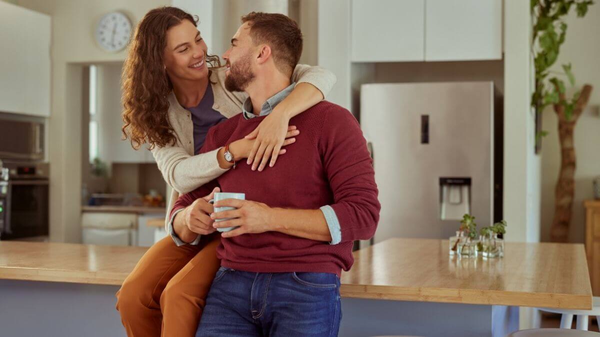A couple embracing in the kitchen