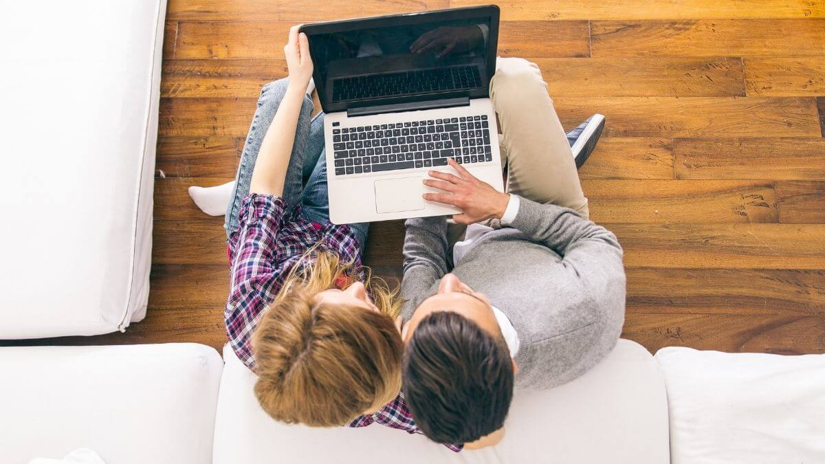 Couple looking at a laptop together